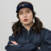 Woman wearing "America First" visor.