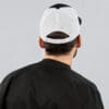 Man wearing black and white trucker hat.