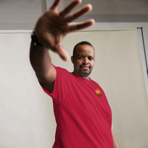 Man in red shirt, hand outstretched.